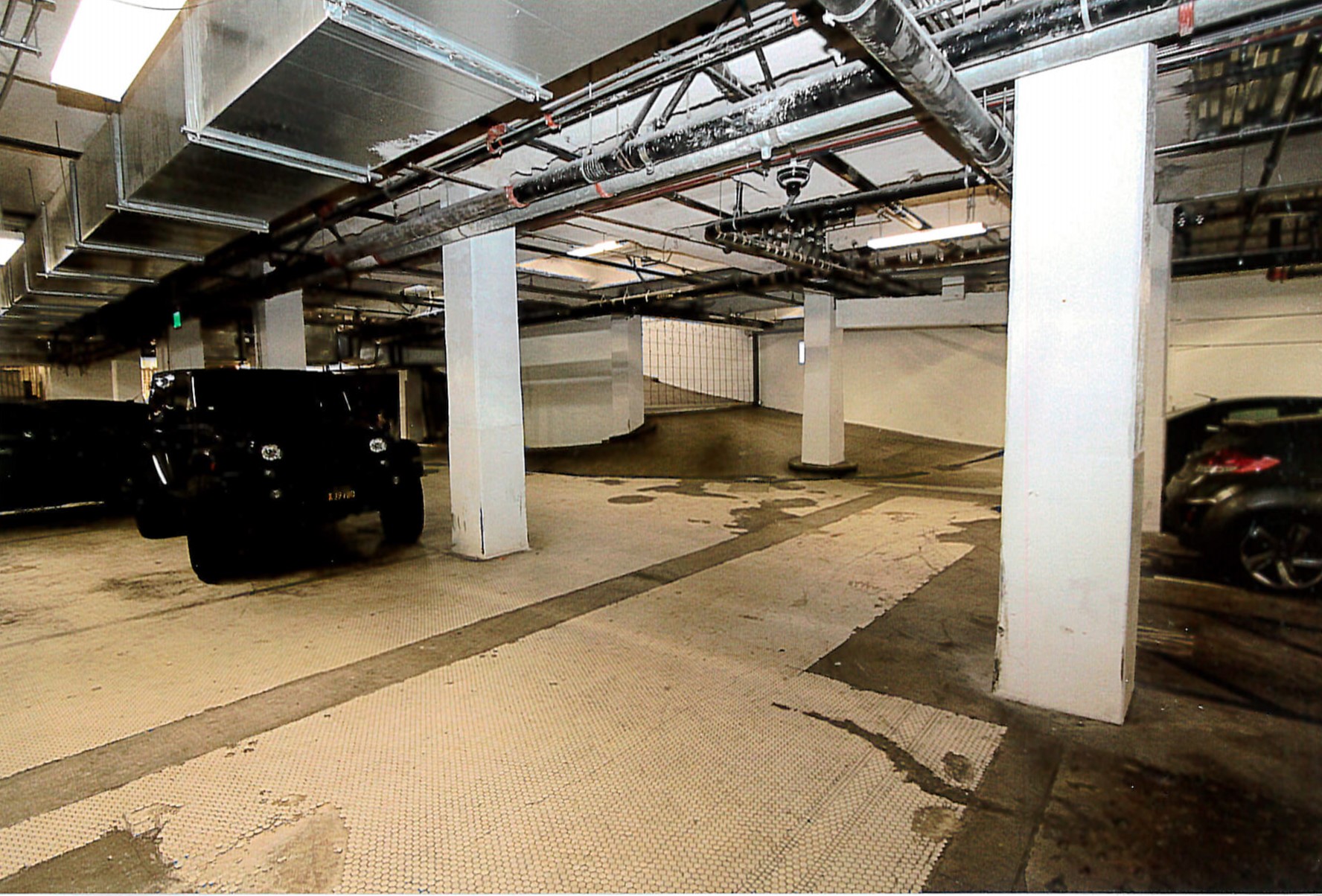 Rehabilitated basement parking garage, added pipework and security gate